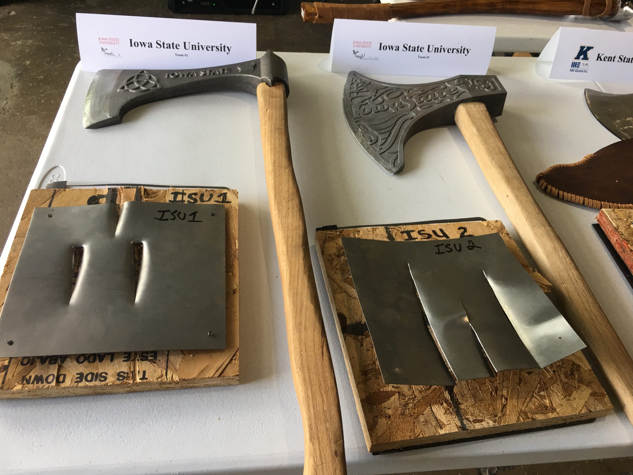 Iowa State University Axes in competition next to pierced steel plates